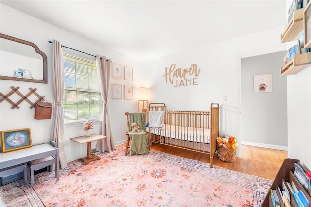 2136 Bainbridge Dr, Salem, VA 24153 - bedroom with wood finished floors, baseboards, and a nursery area