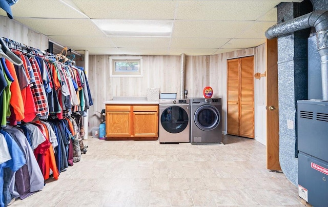 2136 Bainbridge Dr, Salem, VA 24153 - laundry room featuring independent washer and dryer, cabinet space, light floors, and wood walls