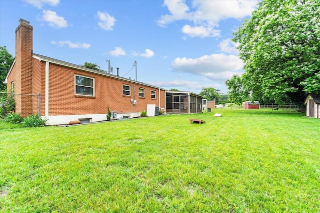 2136 Bainbridge Dr, Salem, VA 24153 - back of house with a chimney, a sunroom, and brick siding