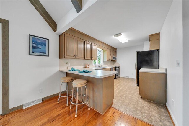 48 Overlook Rd, Hardy, VA 24101 - kitchen featuring light countertops, a breakfast bar area, a sink, a peninsula, and freestanding refrigerator