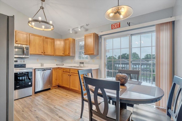 1152 Murray Ave SE, Roanoke, VA 24013 - kitchen featuring appliances with stainless steel finishes, a chandelier, light countertops, a sink, and light wood-type flooring