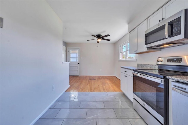 3734 Long Meadow Ave NW, Roanoke, VA 24017 - kitchen with appliances with stainless steel finishes, a ceiling fan, white cabinetry, and baseboards