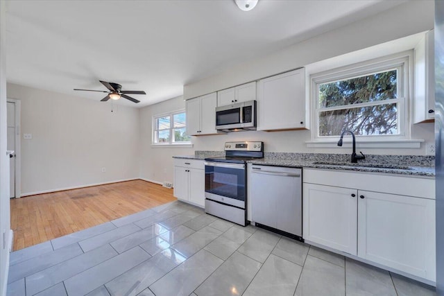 3734 Long Meadow Ave NW, Roanoke, VA 24017 - kitchen with appliances with stainless steel finishes, a sink, stone counters, and white cabinetry