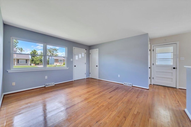 3734 Long Meadow Ave NW, Roanoke, VA 24017 - unfurnished living room featuring healthy amount of natural light, light wood-style floors, and baseboards