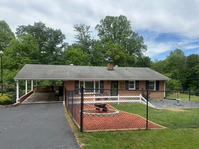 586 Graceland Dr, Bassett, VA 24055 - ranch-style home with asphalt driveway, a chimney, and an attached carport