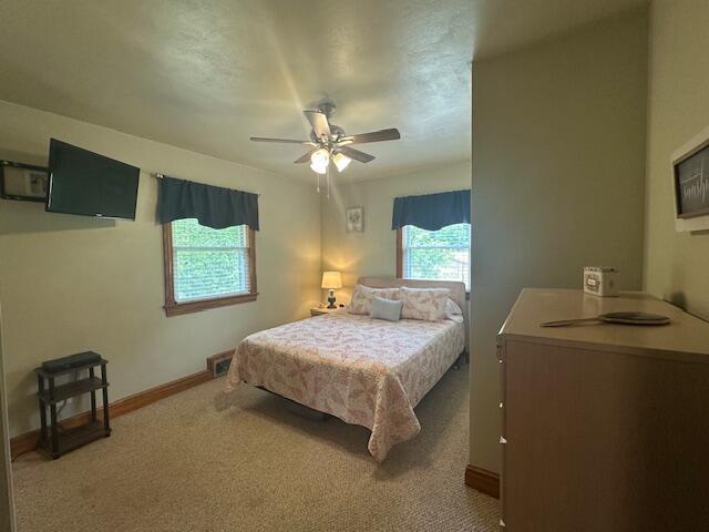 586 Graceland Dr, Bassett, VA 24055 - carpeted bedroom with baseboards and ceiling fan