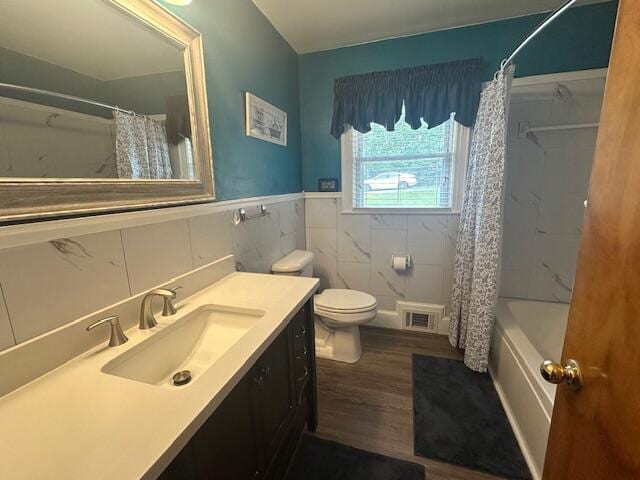 586 Graceland Dr, Bassett, VA 24055 - full bath featuring tile walls, wood finished floors, vanity, toilet, and shower / bathtub combination with curtain