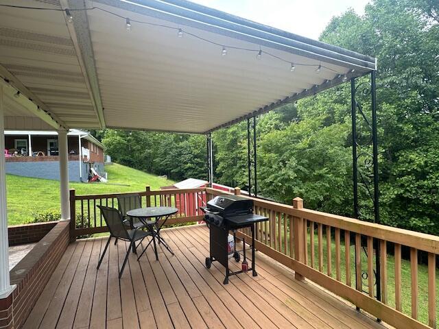 586 Graceland Dr, Bassett, VA 24055 - deck with area for grilling and a lawn