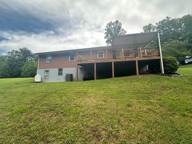 586 Graceland Dr, Bassett, VA 24055 - back of property featuring central AC, a wooden deck, and a yard