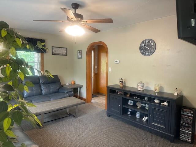 586 Graceland Dr, Bassett, VA 24055 - carpeted living area featuring arched walkways and ceiling fan