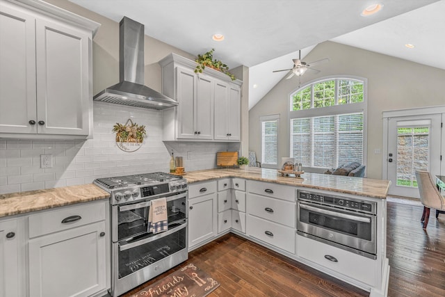 700 Thornblade Way, Blue Ridge, VA 24064 - kitchen with wall chimney exhaust hood, appliances with stainless steel finishes, a ceiling fan, vaulted ceiling, and a peninsula