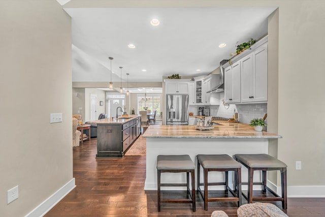 700 Thornblade Way, Blue Ridge, VA 24064 - kitchen featuring stainless steel fridge with ice dispenser, baseboards, a sink, a peninsula, and wall chimney exhaust hood