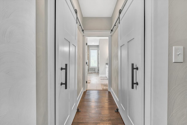 700 Thornblade Way, Blue Ridge, VA 24064 - hall featuring a barn door, dark wood-type flooring, and baseboards