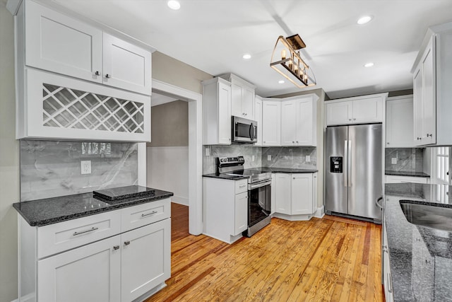 4816 Colonial Ave, Roanoke, VA 24018 - kitchen featuring appliances with stainless steel finishes, decorative backsplash, light wood-type flooring, white cabinetry, and recessed lighting