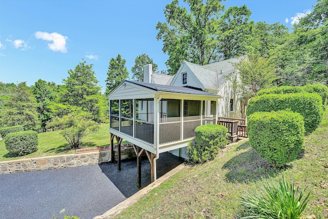 4816 Colonial Ave, Roanoke, VA 24018 - view of front facade featuring a sunroom, a chimney, and a front yard