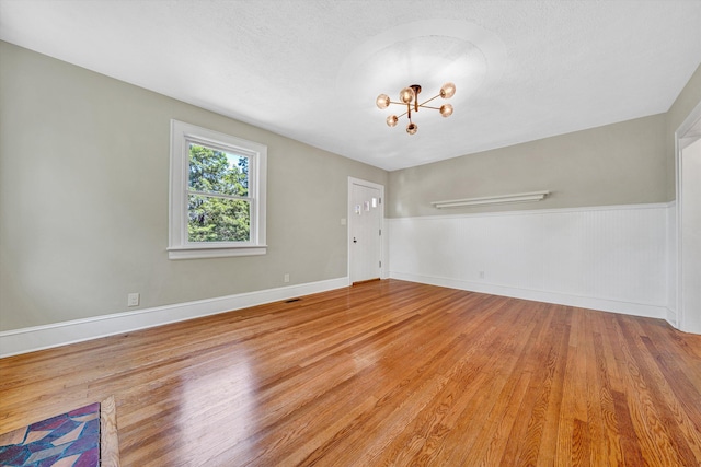 4816 Colonial Ave, Roanoke, VA 24018 - empty room with light wood-type flooring, a chandelier, and baseboards
