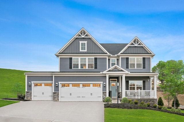 7272 Fairway Ridge Cir, Salem, VA 24153 - craftsman-style house featuring board and batten siding, a porch, a front yard, stone siding, and driveway