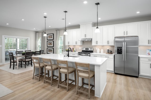 7272 Fairway Ridge Cir, Salem, VA 24153 - kitchen with stainless steel appliances, light wood finished floors, tasteful backsplash, a sink, and recessed lighting