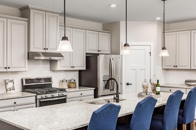 7229 Fairway Ridge Cir, Salem, VA 24153 - kitchen featuring stainless steel appliances, under cabinet range hood, a sink, a kitchen bar, and light stone countertops
