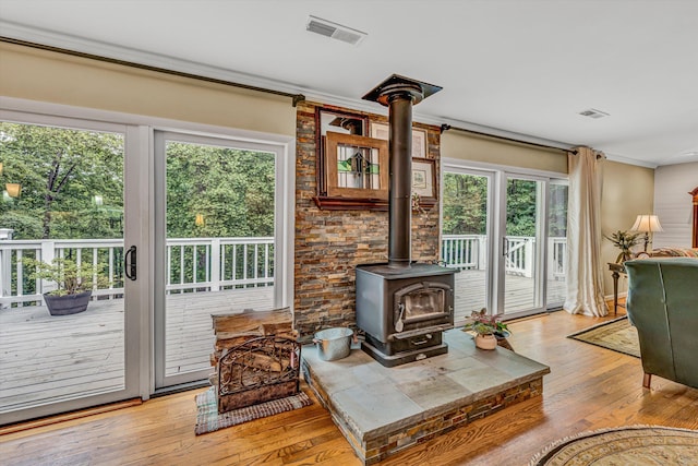 402 Anchor Dr, Moneta, VA 24121 - living area featuring a wood stove, plenty of natural light, light wood-type flooring, and crown molding
