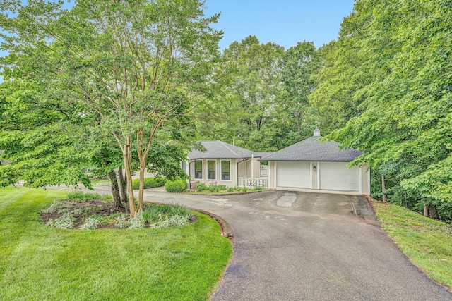 402 Anchor Dr, Moneta, VA 24121 - view of front facade featuring an attached garage, driveway, a front lawn, and a shingled roof