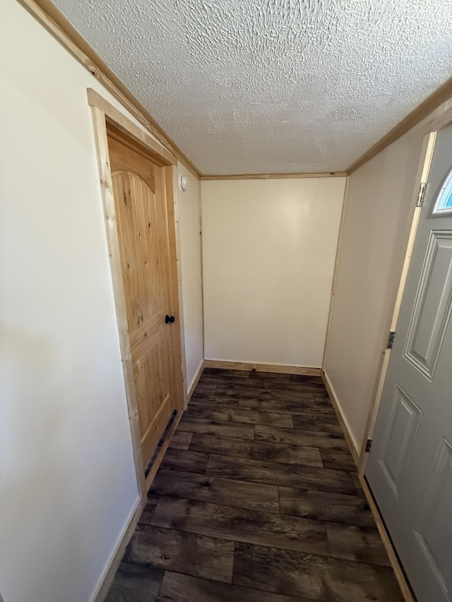 7506 Roaring Run Rd Unit 1, Covington, VA 24426 - hallway with a textured ceiling, dark wood-style flooring, crown molding, and baseboards