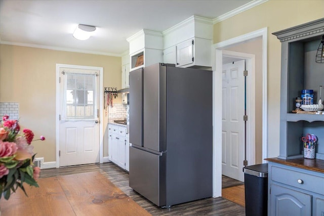 160 Mountain View Dr, Rocky Mount, VA 24151 - kitchen featuring freestanding refrigerator, dark wood-style floors, white cabinetry, ornamental molding, and under cabinet range hood