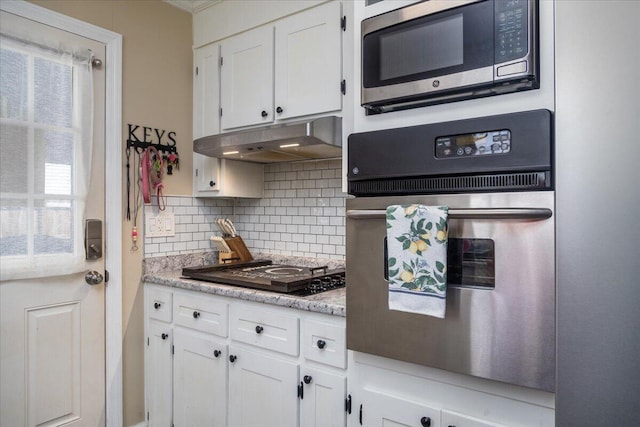 160 Mountain View Dr, Rocky Mount, VA 24151 - kitchen featuring stainless steel appliances, white cabinetry, backsplash, under cabinet range hood, and crown molding