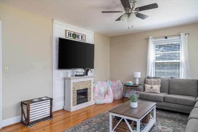 160 Mountain View Dr, Rocky Mount, VA 24151 - living room with wood finished floors, ceiling fan, a stone fireplace, and baseboards