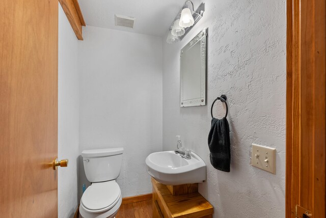 1539 Wheats Valley Rd, Bedford, VA 24523 - half bath featuring toilet, wood finished floors, vanity, and baseboards