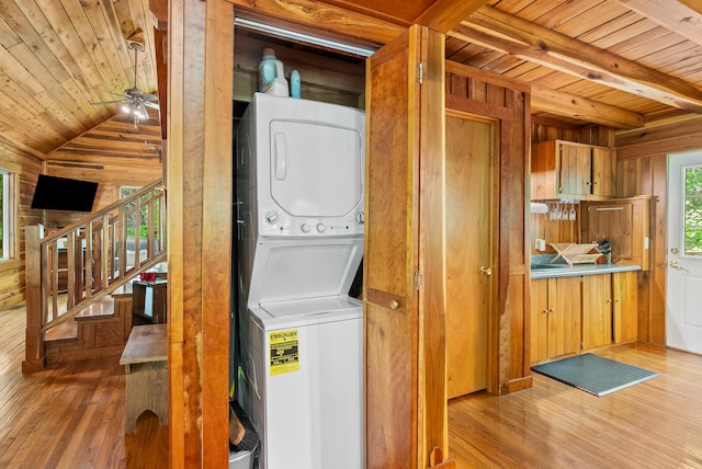 1539 Wheats Valley Rd, Bedford, VA 24523 - washroom featuring stacked washer / dryer, wood walls, wooden ceiling, light wood-style flooring, and ceiling fan