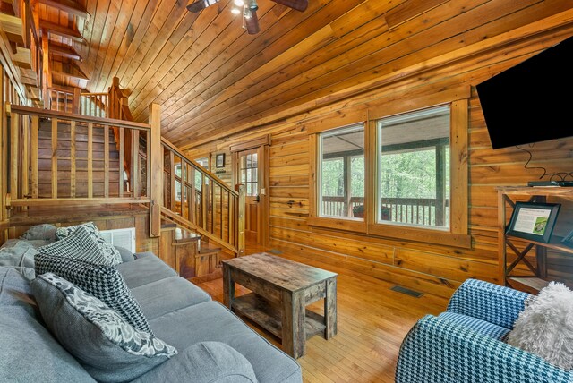1539 Wheats Valley Rd, Bedford, VA 24523 - living room with stairway, wooden walls, wood ceiling, a ceiling fan, and lofted ceiling