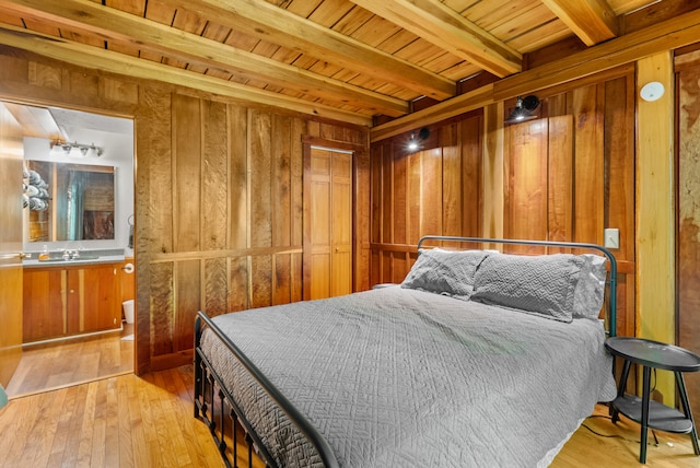 1539 Wheats Valley Rd, Bedford, VA 24523 - bedroom with wooden walls, wooden ceiling with exposed beams, hardwood / wood-style floors, and a sink