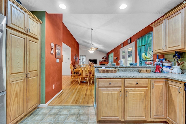7123 Tall Oak Ln, Roanoke, VA 24018 - kitchen with a peninsula, vaulted ceiling, light stone counters, pendant lighting, and light tile patterned floors