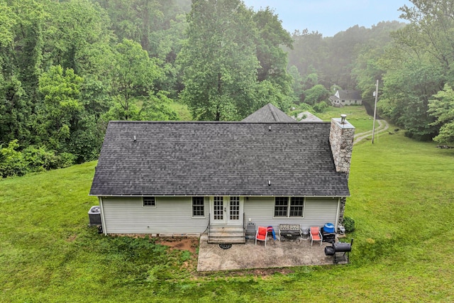 7123 Tall Oak Ln, Roanoke, VA 24018 - back of house with french doors, a patio, a lawn, a shingled roof, and a wooded view