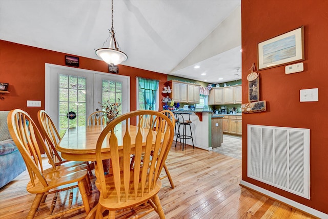 7123 Tall Oak Ln, Roanoke, VA 24018 - dining area with light wood-style floors, french doors, and vaulted ceiling