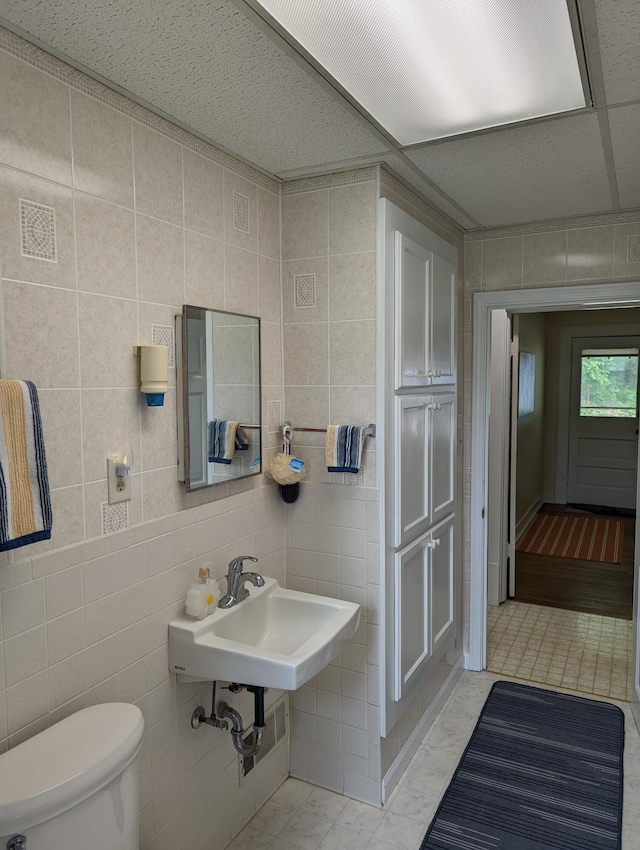 150 Harvey St, Rocky Mount, VA 24151 - half bath featuring toilet, tile walls, and a sink