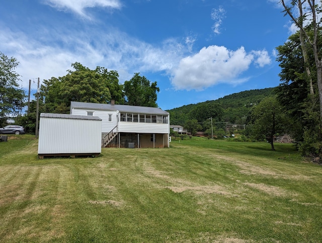 150 Harvey St, Rocky Mount, VA 24151 - back of property featuring stairway, a yard, a chimney, a sunroom, and a deck