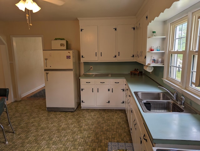 150 Harvey St, Rocky Mount, VA 24151 - kitchen featuring freestanding refrigerator, a sink, white cabinetry, and ceiling fan