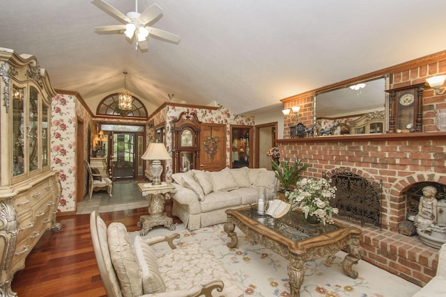 157 Burks Hollow Rd SW, Willis, VA 24380 - living area featuring wood finished floors, vaulted ceiling, ceiling fan, and a brick fireplace