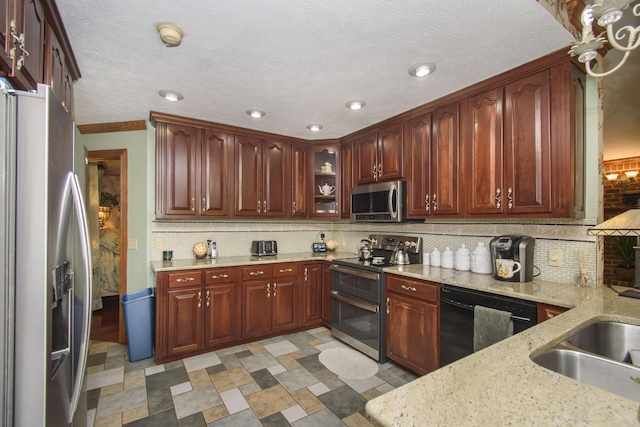 157 Burks Hollow Rd SW, Willis, VA 24380 - kitchen featuring appliances with stainless steel finishes, decorative backsplash, light stone countertops, recessed lighting, and glass insert cabinets