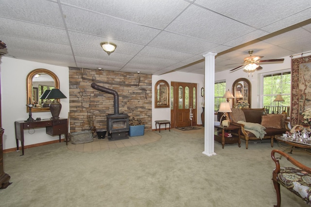157 Burks Hollow Rd SW, Willis, VA 24380 - living area with a wood stove, a paneled ceiling, carpet flooring, baseboards, and ceiling fan