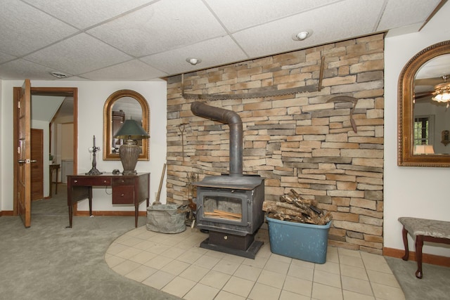 157 Burks Hollow Rd SW, Willis, VA 24380 - detailed view of a drop ceiling, a wood stove, baseboards, and carpet floors