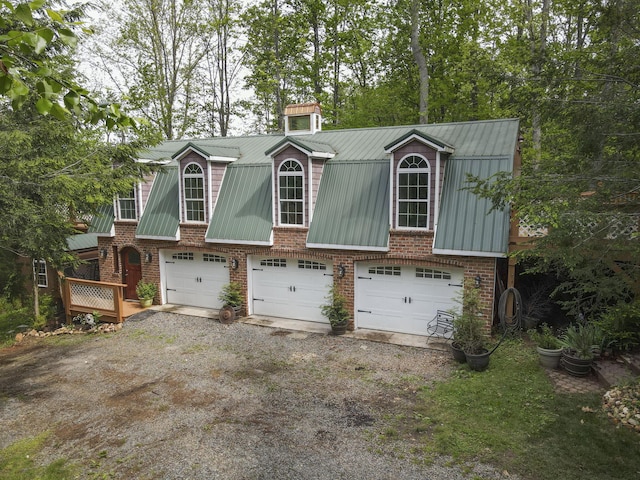 157 Burks Hollow Rd SW, Willis, VA 24380 - view of front facade featuring driveway, brick siding, metal roof, and an attached garage