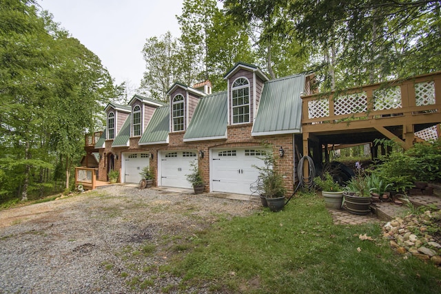 157 Burks Hollow Rd SW, Willis, VA 24380 - view of front of property featuring driveway, metal roof, brick siding, a garage, and a deck