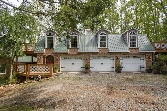 157 Burks Hollow Rd SW, Willis, VA 24380 - view of front of home featuring driveway, brick siding, metal roof, and a garage