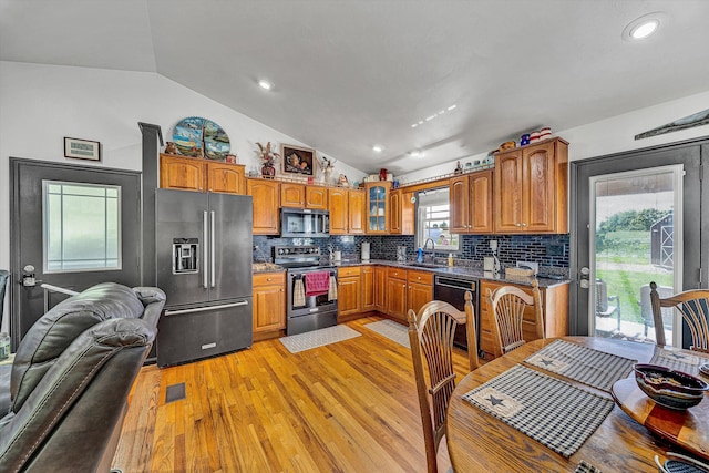 22 Spring Branch Ln, Fincastle, VA 24090 - kitchen with appliances with stainless steel finishes, lofted ceiling, a sink, light wood-type flooring, and backsplash