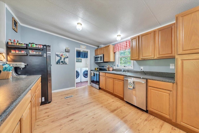 4362 Stewartsville Rd, Moneta, VA 24121 - kitchen with appliances with stainless steel finishes, washing machine and dryer, vaulted ceiling, crown molding, and dark countertops
