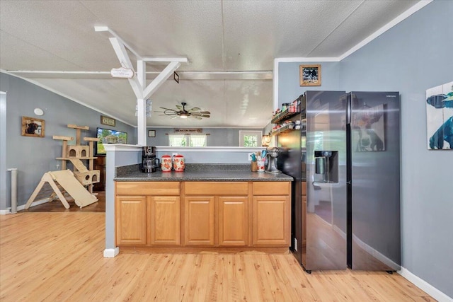 4362 Stewartsville Rd, Moneta, VA 24121 - kitchen with stainless steel fridge, light wood-type flooring, a peninsula, dark countertops, and ceiling fan