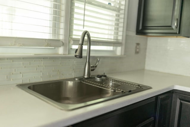 212 Woodland Rd, Bassett, VA 24055 - kitchen view of a sink, tasteful backsplash, and light countertops